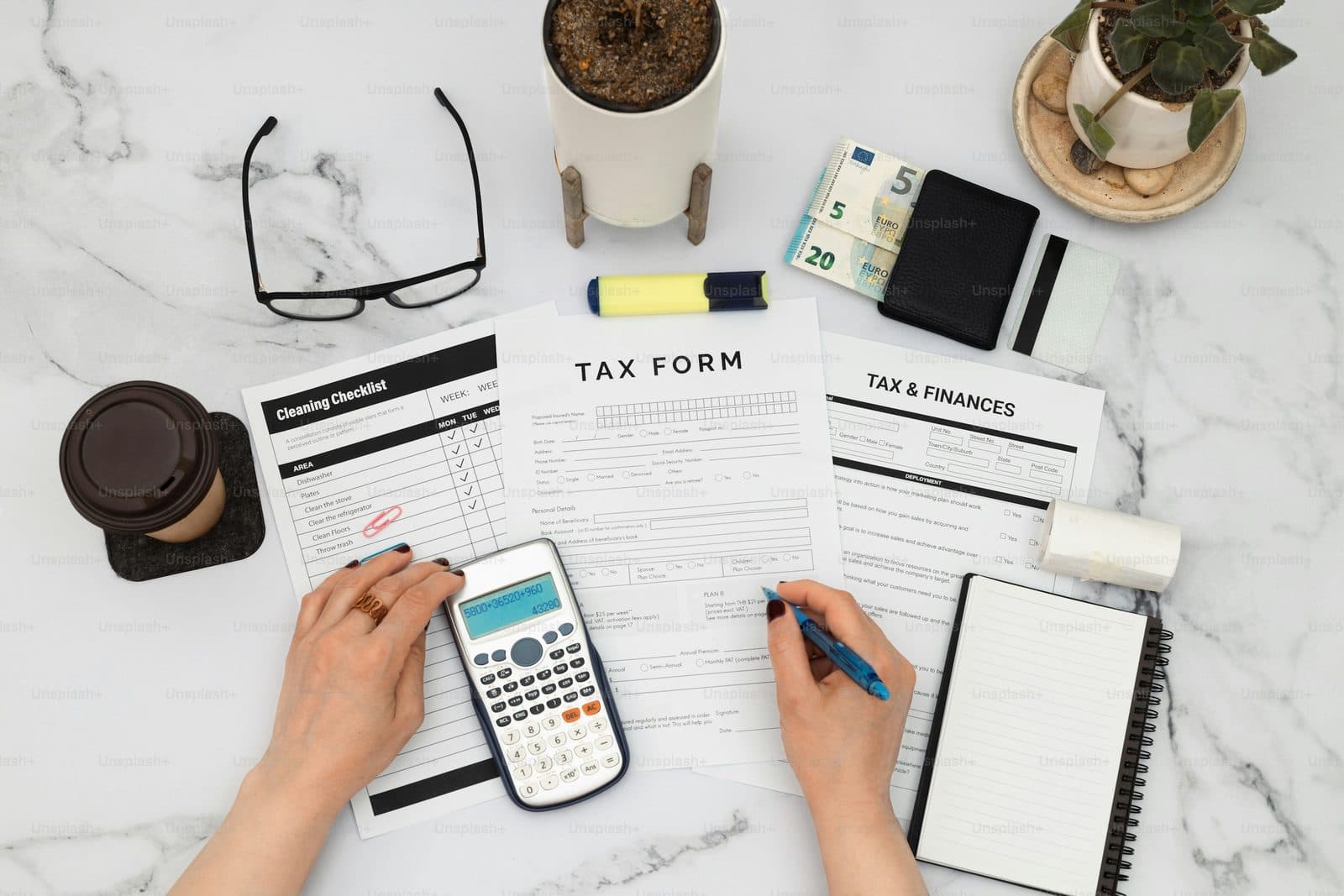 Expense claims and receipts being checked against a calculator